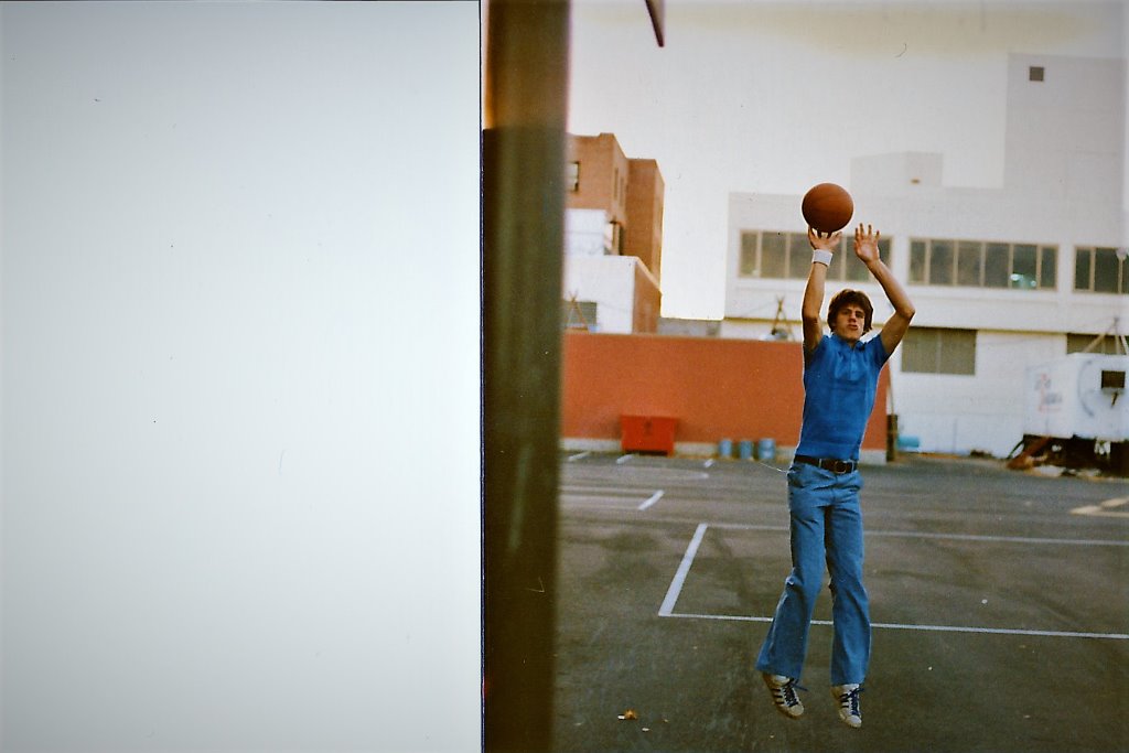 Mark Trigsted, (with lots of hair and very skinny), shooting jumpshots at St. Stans 9-foot hoop.  Autumn 1975